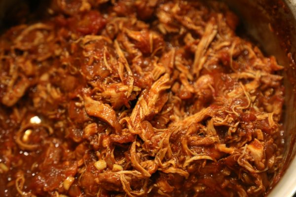 Image of Start checking the shredability of the chicken pieces by giving...