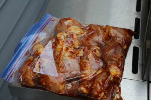 Image of Add marinade to chicken legs in a ziptop plastic bag and...