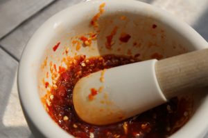 Image of Roughly chop the Thai chilies and garlic and place inside...