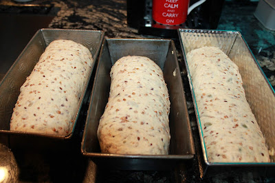 Image of Place the loaves into well-greased bread pans.