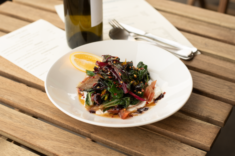 sautéed greens with goat labne & olive jam dressing