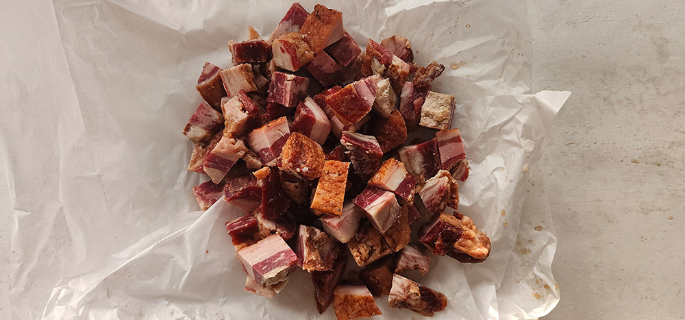 Image of Slice the remainder of the beef belly into cubes.