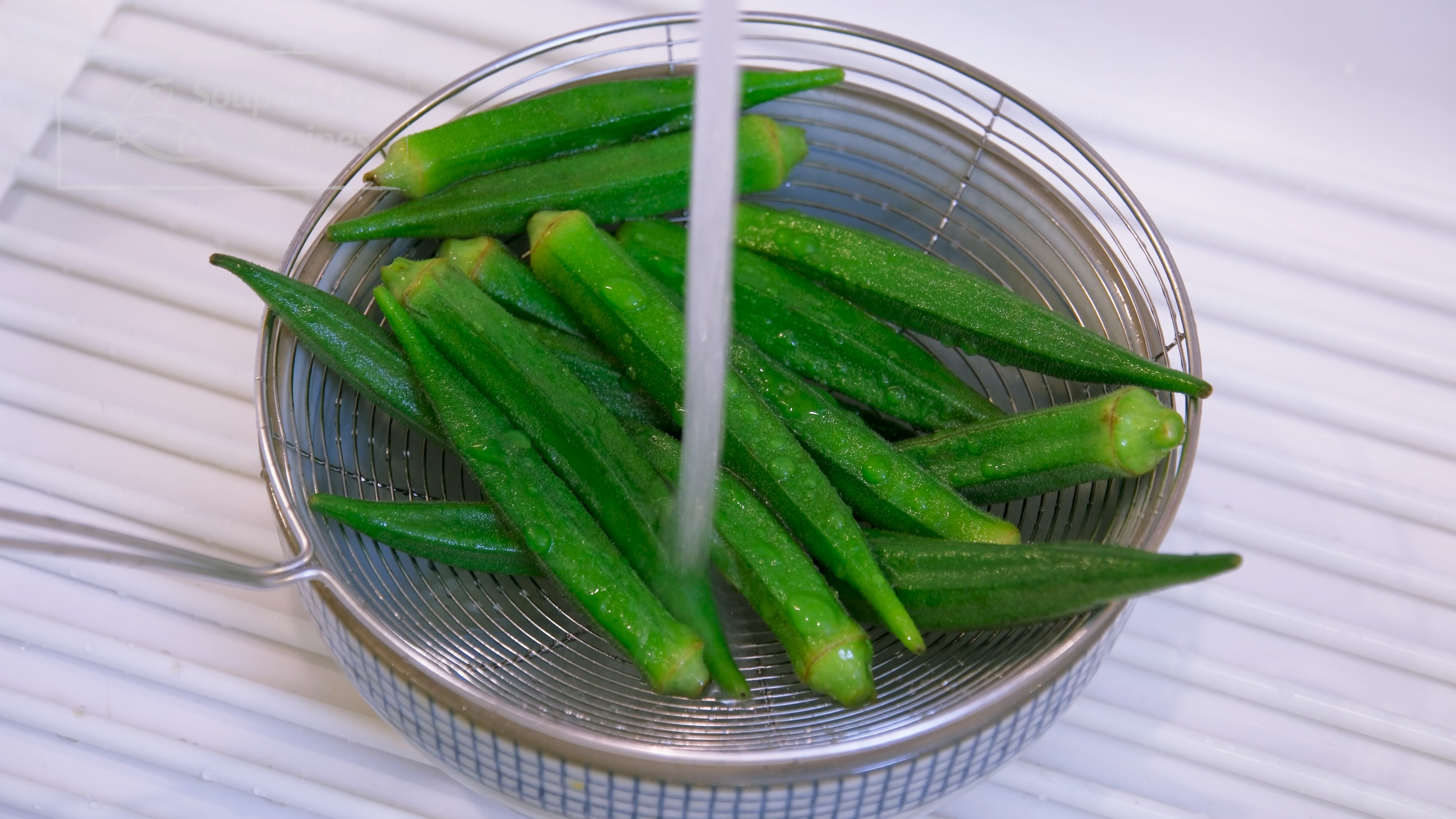 Image of Take the okra out of the pot and rinse under...