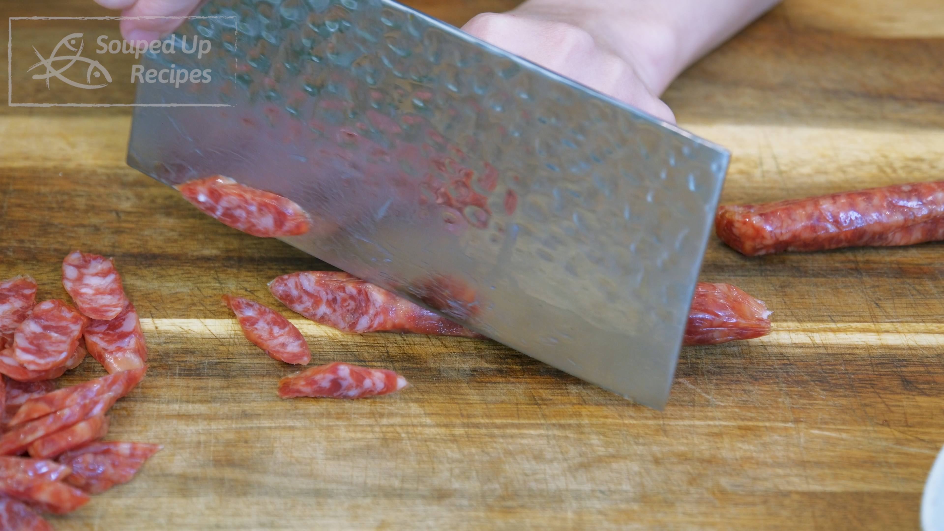 Image of Slice the Cantonese sausage (AKA lap cheong) at a 45-degree...
