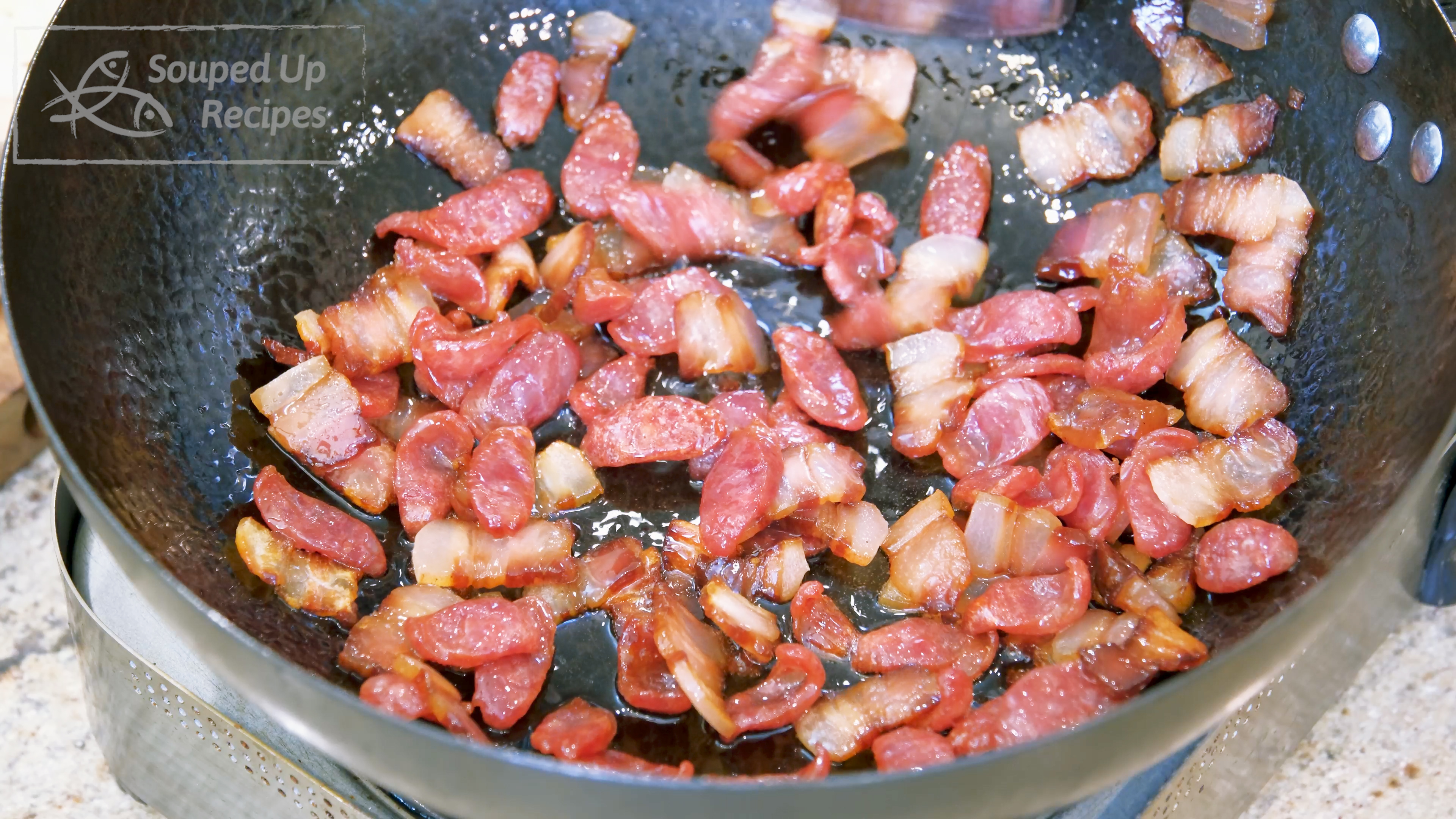 Image of Add the cured bacon and sausage slices into a wok...
