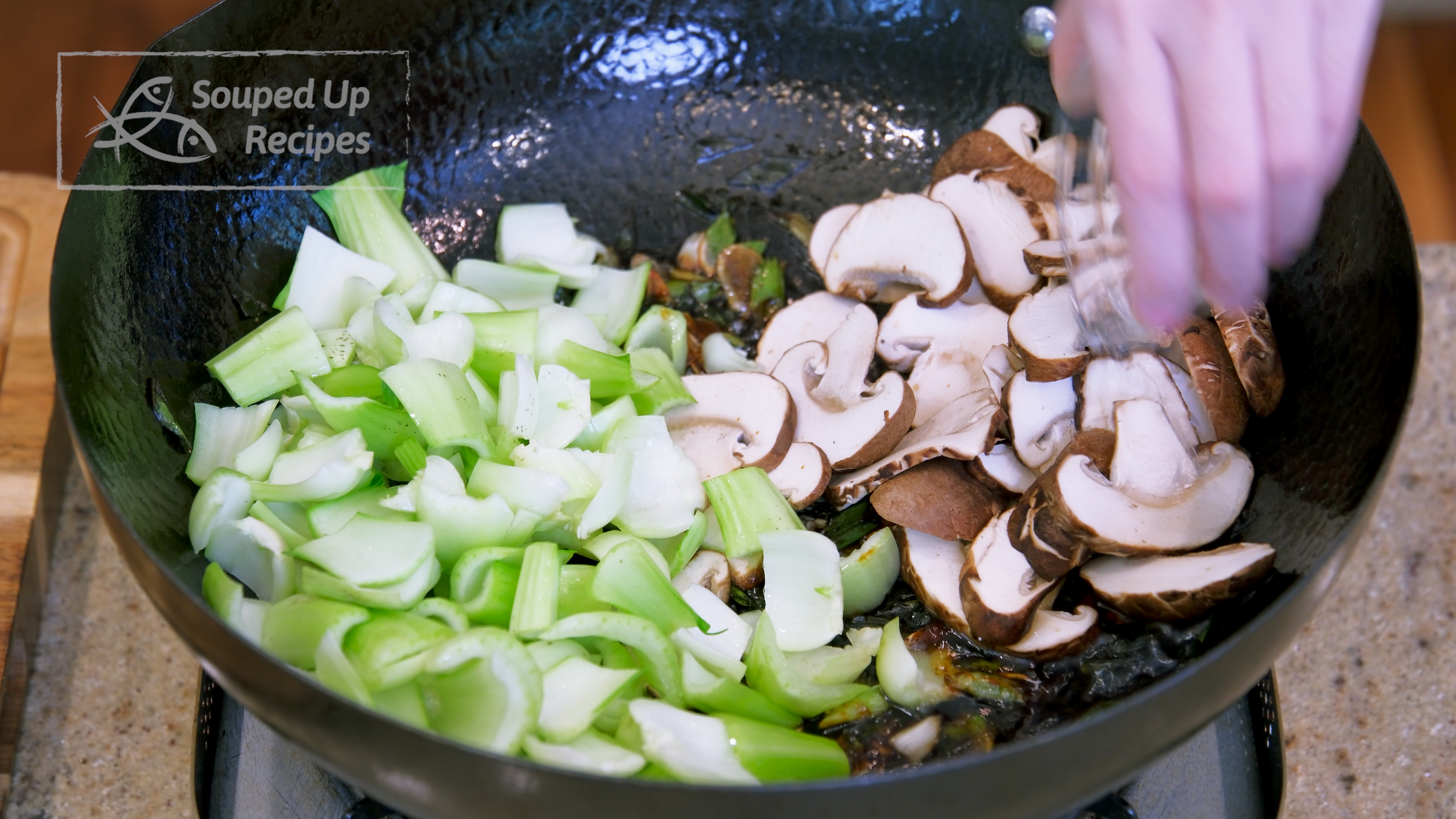 Image of Toss in the bok choy stems and mushroom slices. Drizzle...