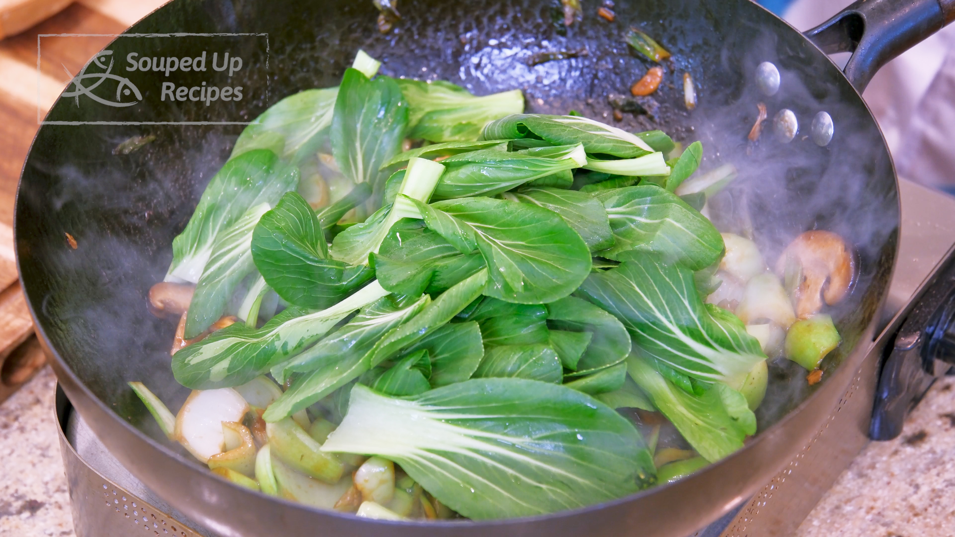 Image of Add the bok choy leaves and continue to stir until...