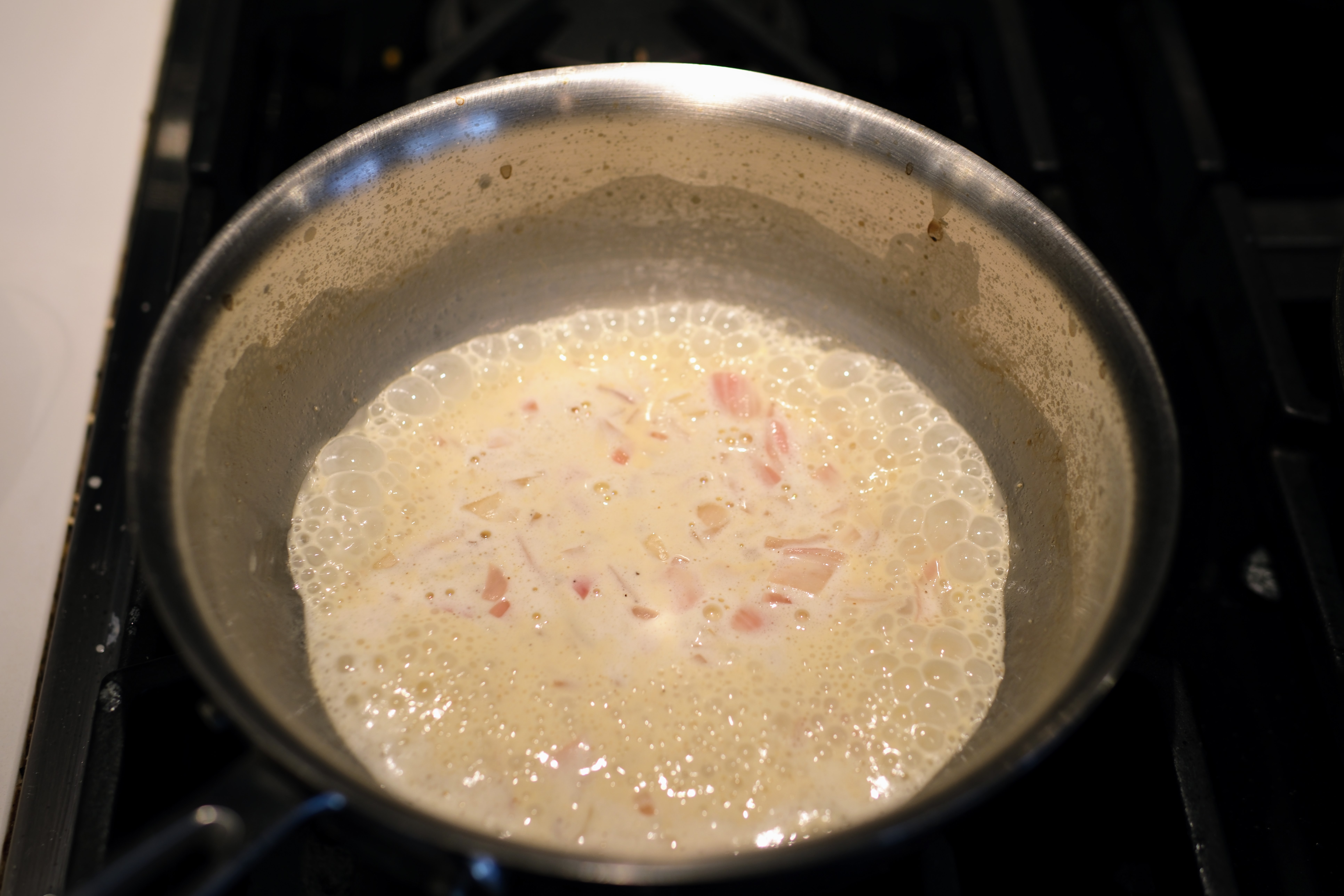 Image of Lower heat to a medium flame and add heavy cream,...