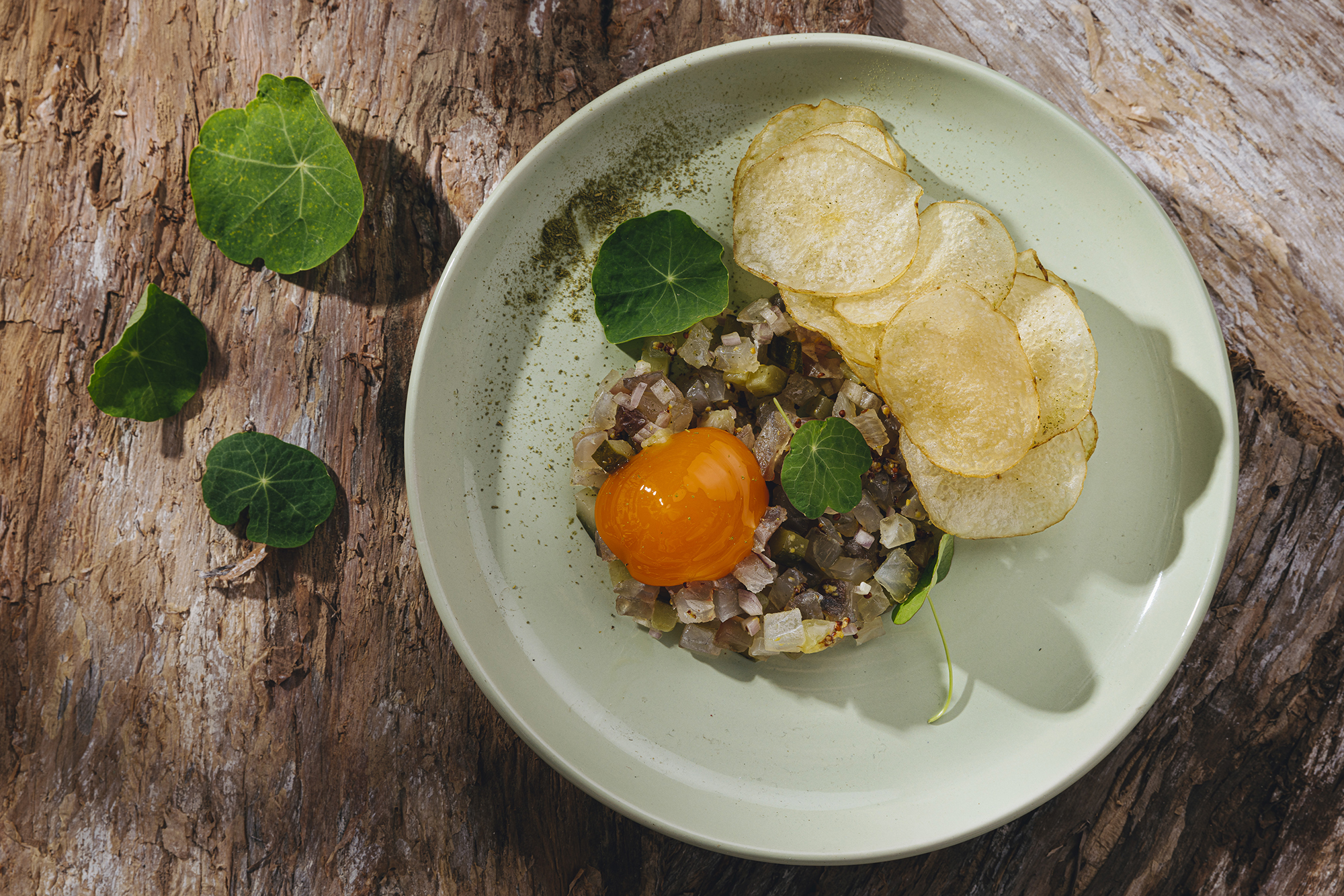 smoked barramundi tartare with smoked extra virgin olive oil, slow-cooked yolk & bay crisps