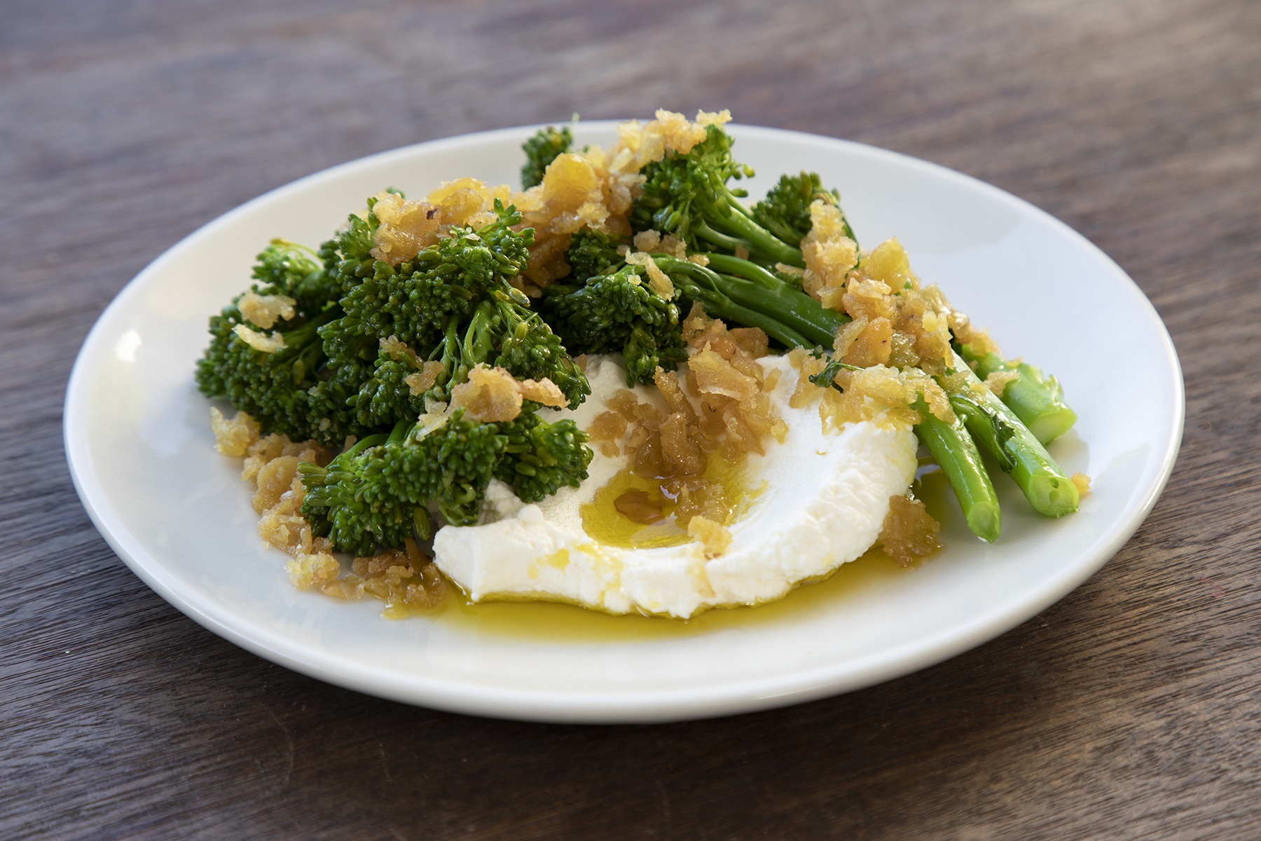 roasted crushed faba beans with cumin, lime, broccolini & labne
