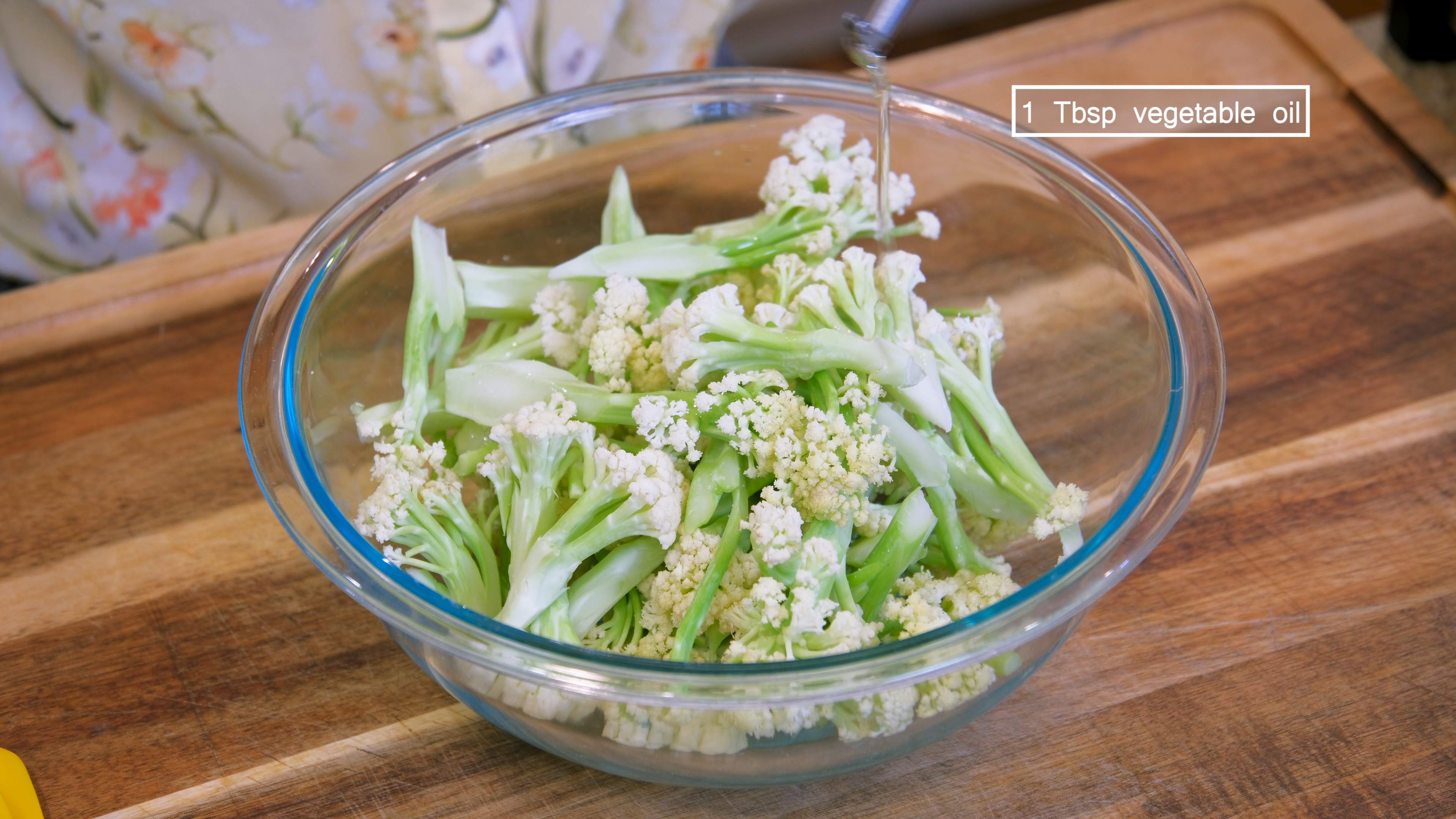 Image of Cut the cauliflower into small florets. Add a drizzle of...