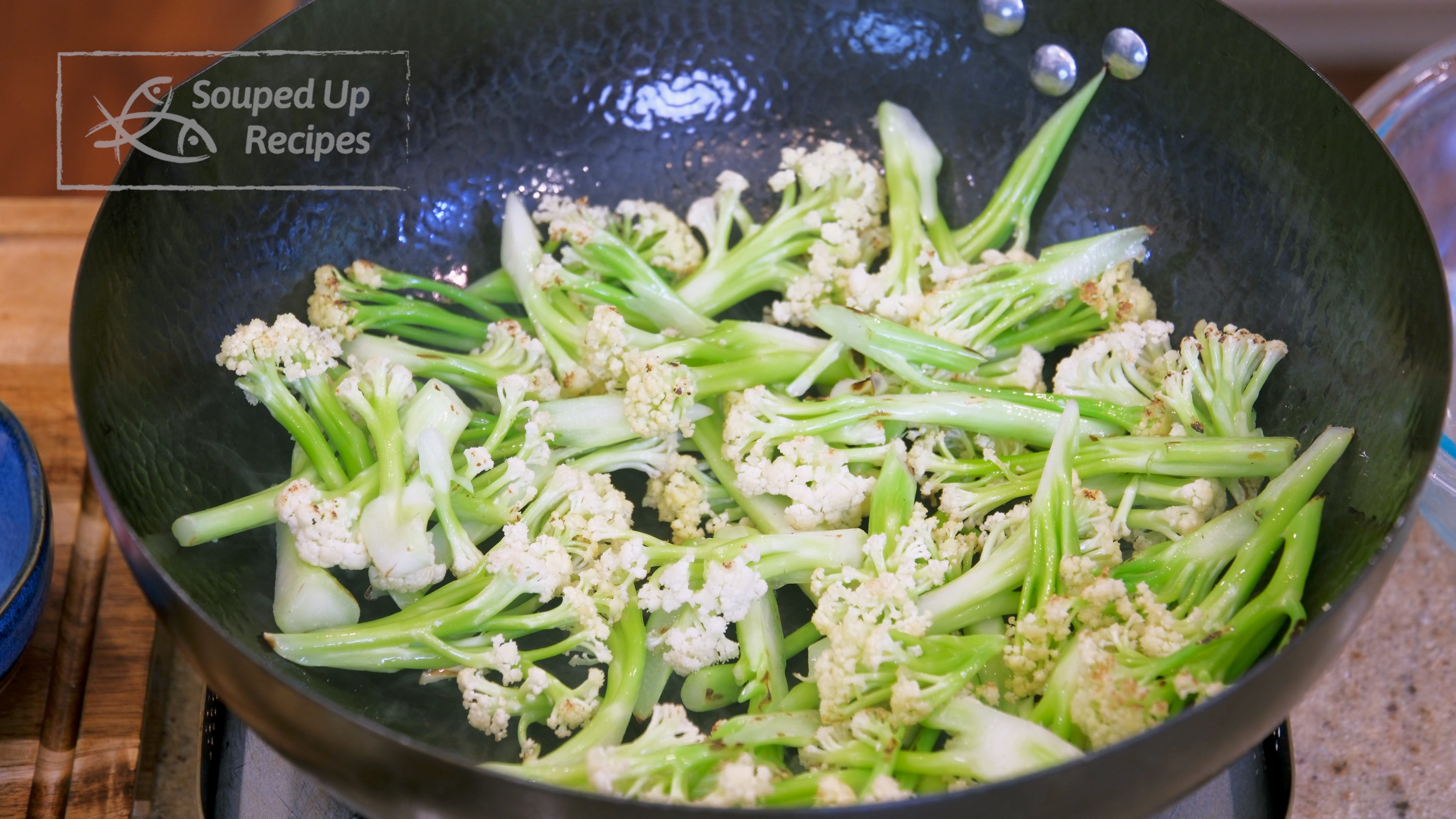 Image of Add the cauliflower to the wok and stir over medium...