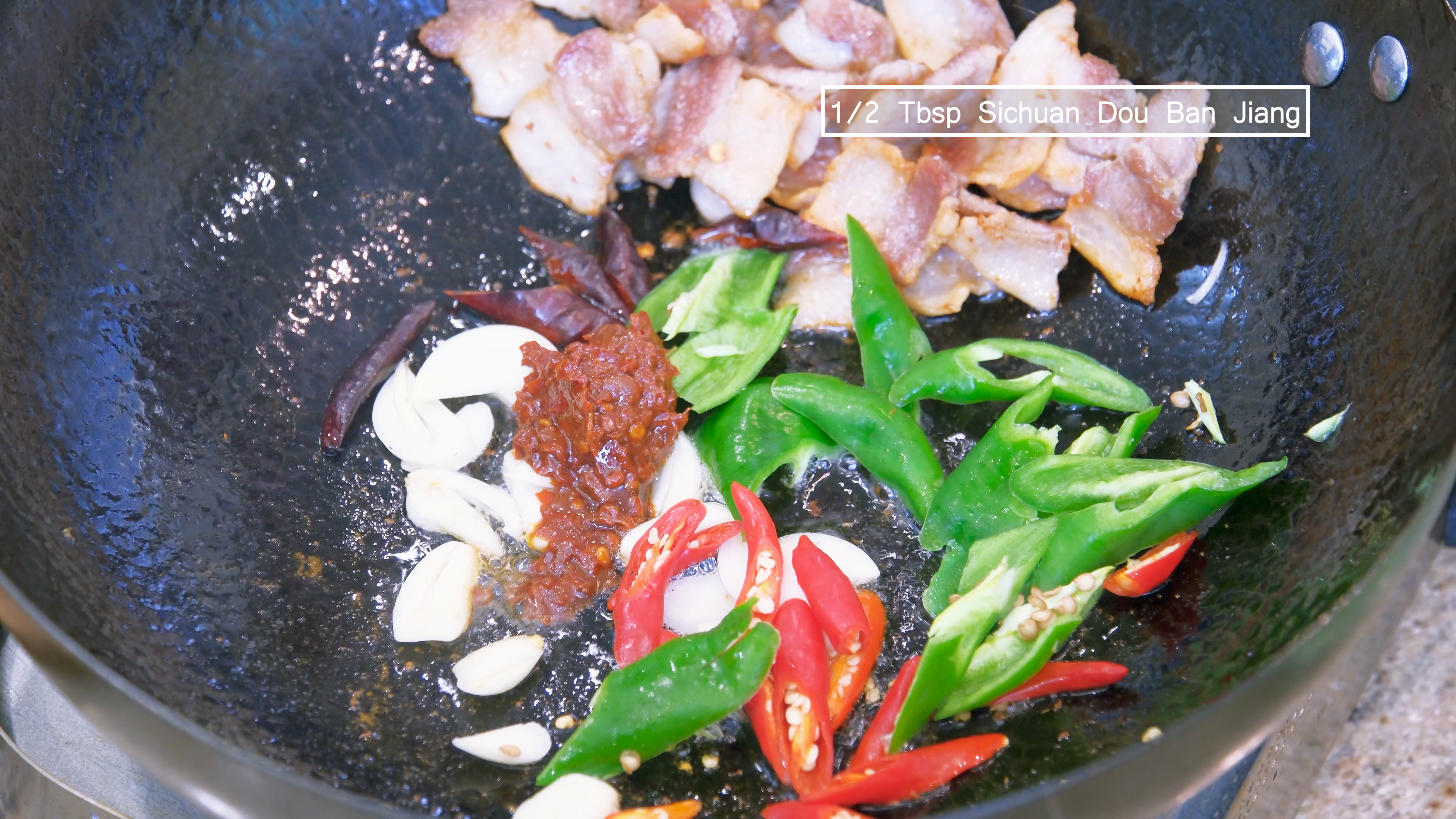 Image of Add the garlic slices, diced Thai bird eye chilies, green...