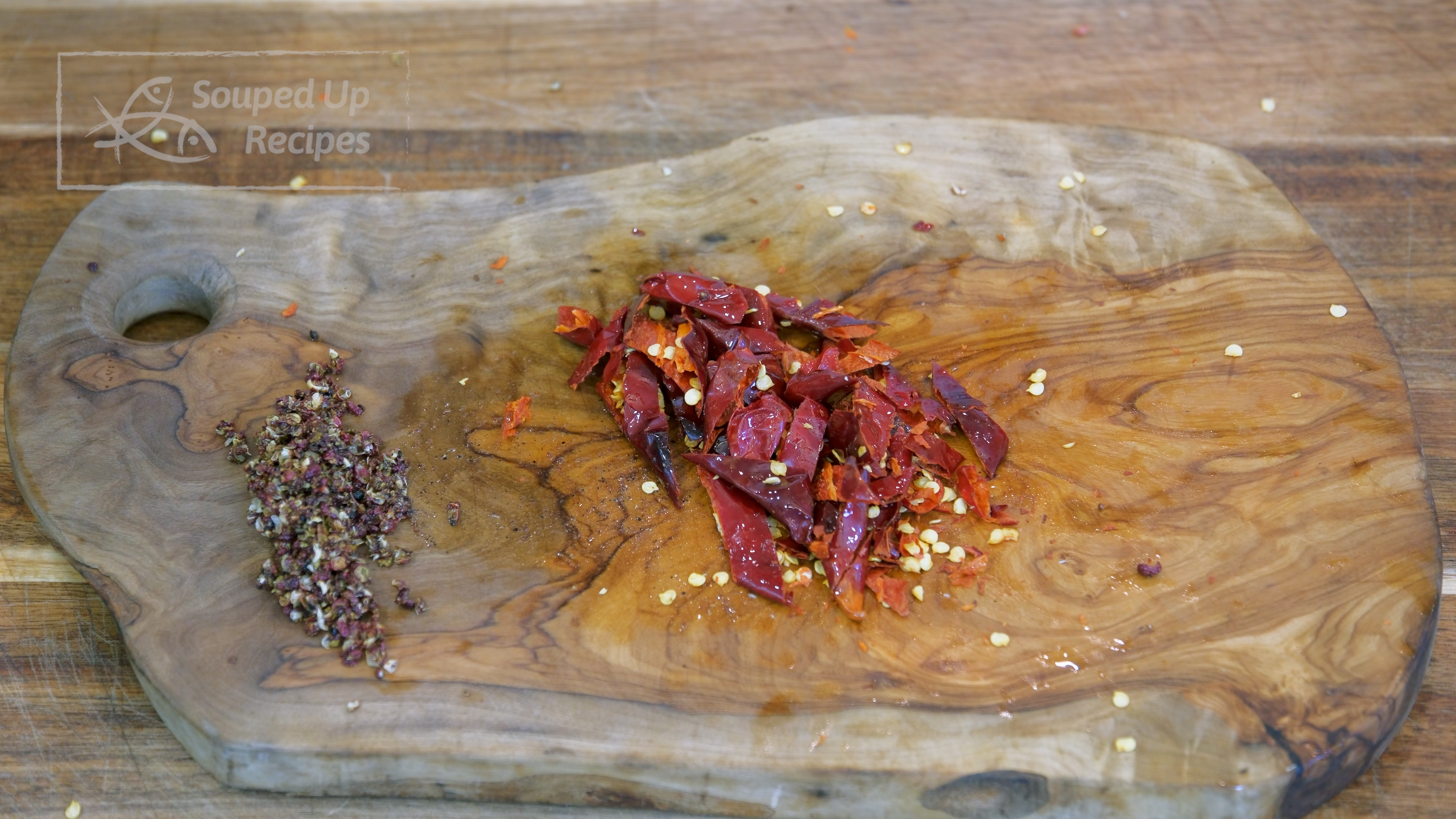 Image of During this time, press the Sichuan peppercorn with a heavy-duty cleaver, then...