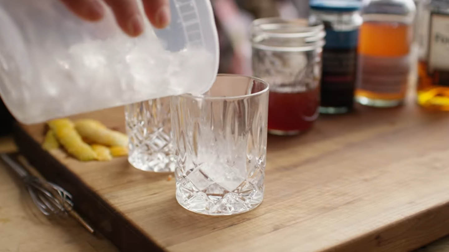 Image of Fill two rocks glasses with ice, then divide the mixture...