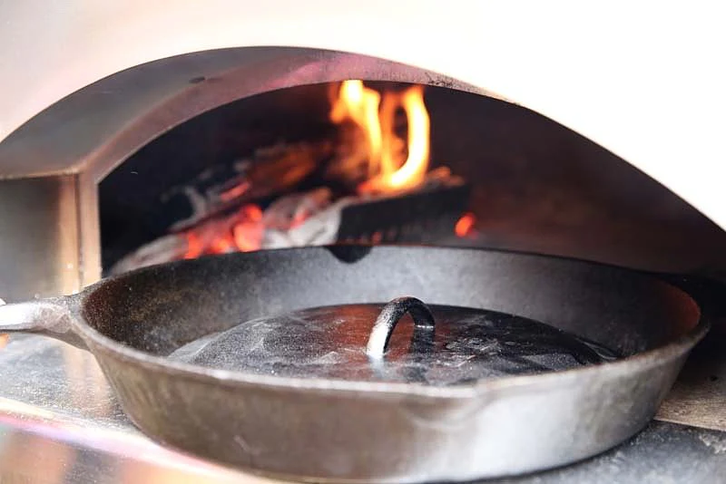 Image of A cast iron skillet with a lid (the lid must be a...