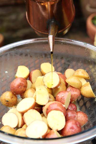 Image of Drizzle olive oil on the potatoes