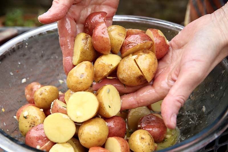 Image of Stir well making sure the potatoes are coated with the...