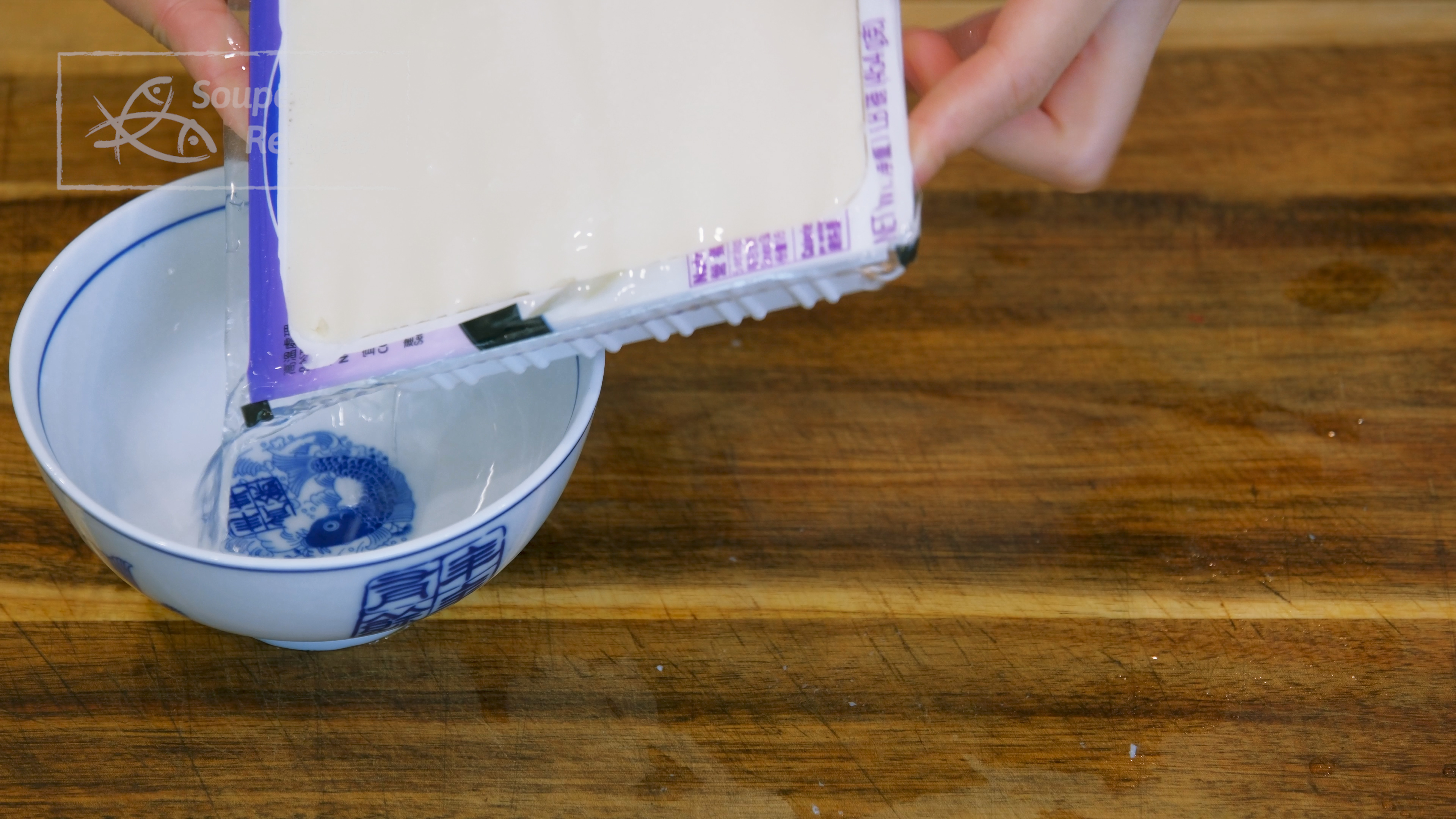 Image of Open the silken tofu package and pour out the excess...