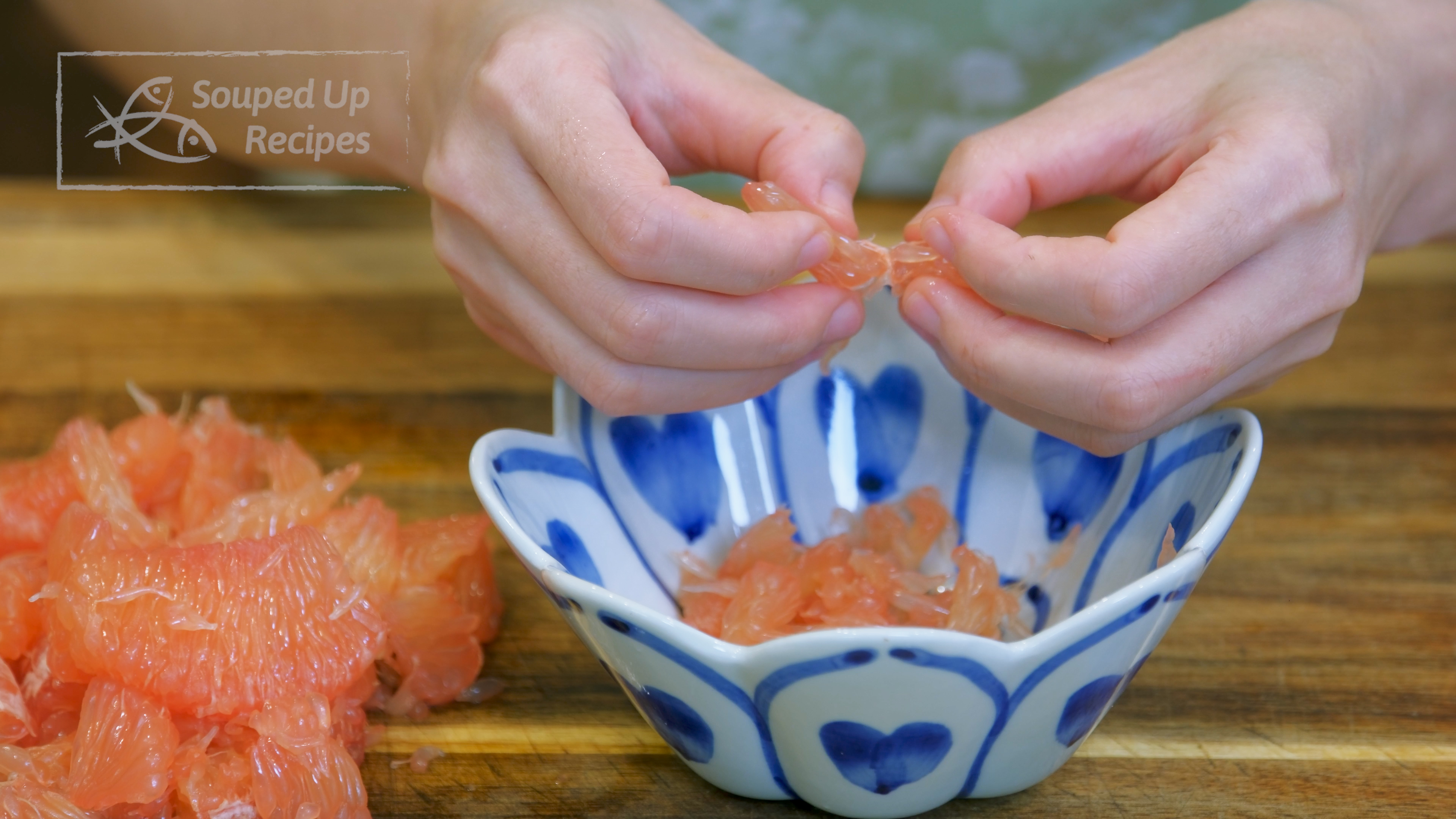 Image of Carefully peel off the translucent membrane and take the grapefruit meat out. Tear the...
