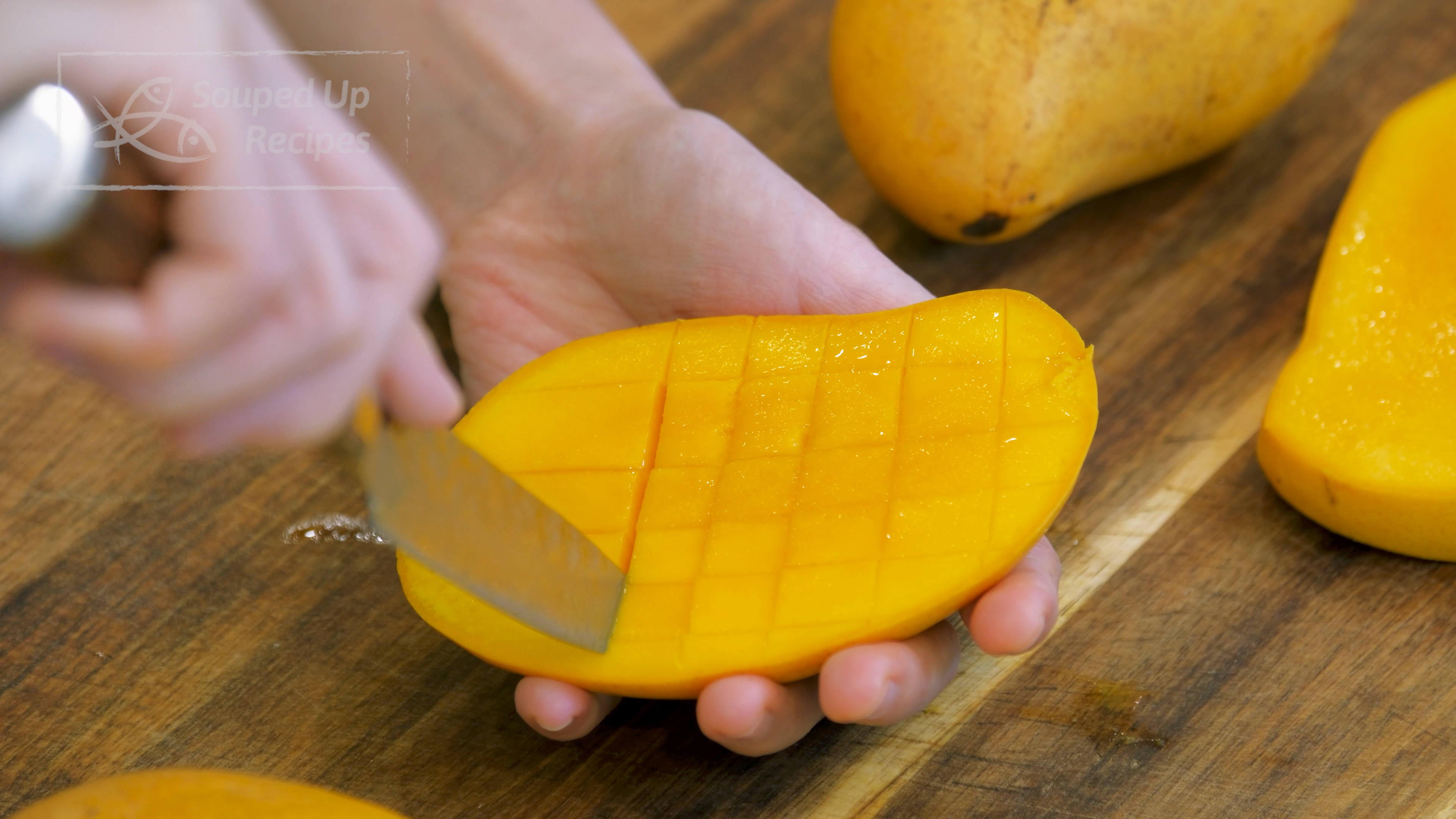 Image of Cut out 3 ripe mangos. Slice the mango down slightly off the...
