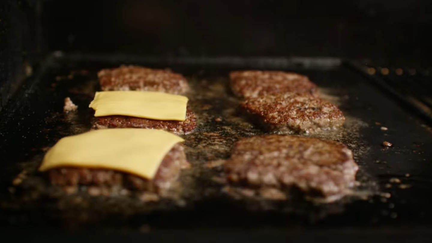 Image of Place the burger patties on the griddle and cook until...