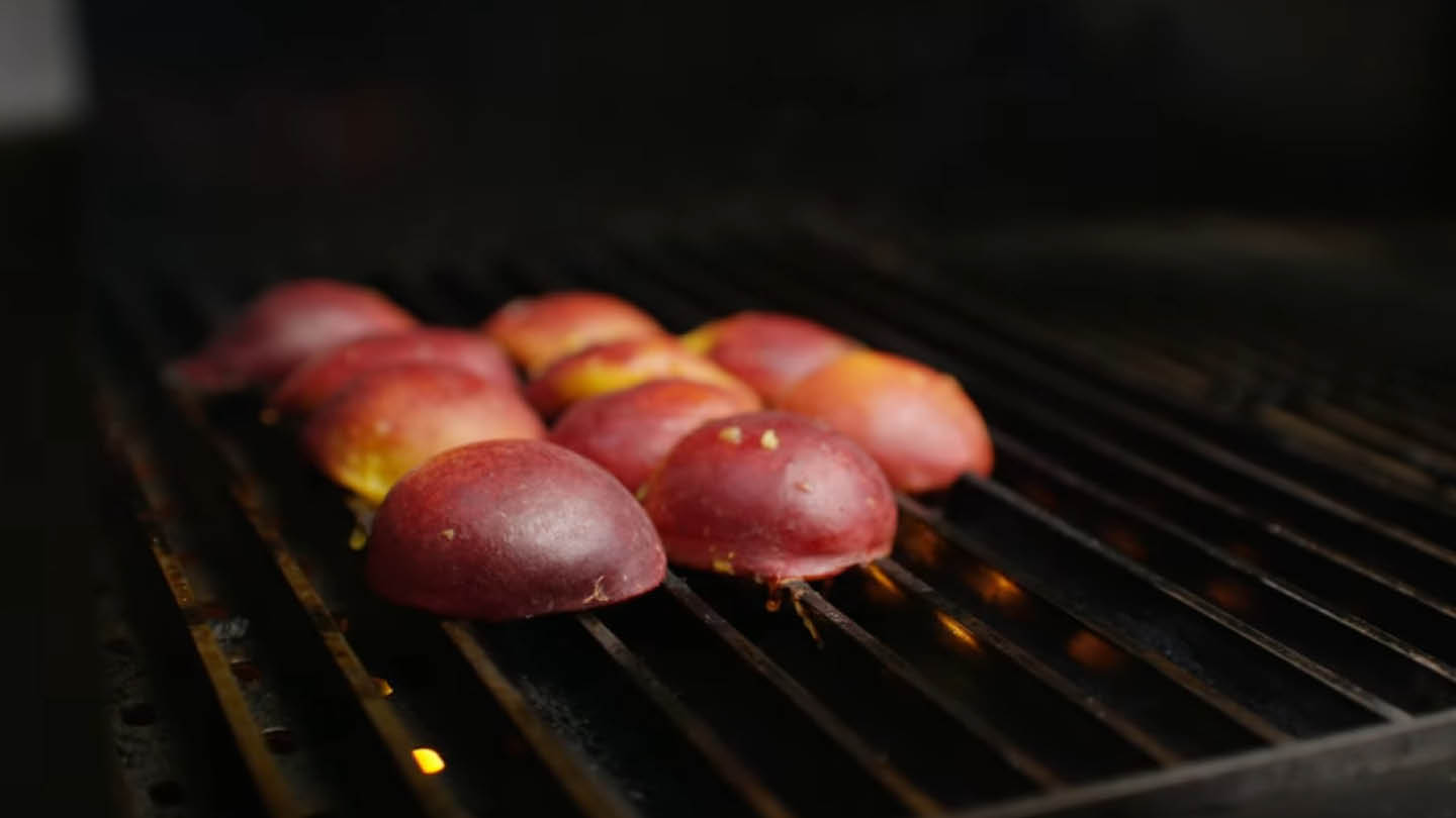 Image of Halve the peaches. Remove the pits. Grill the peaches over...