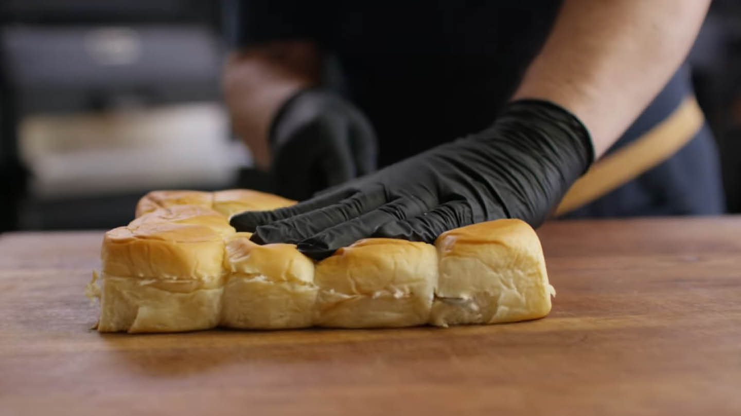 Image of Slice the entire package of Hawaiian rolls in half horizontally.