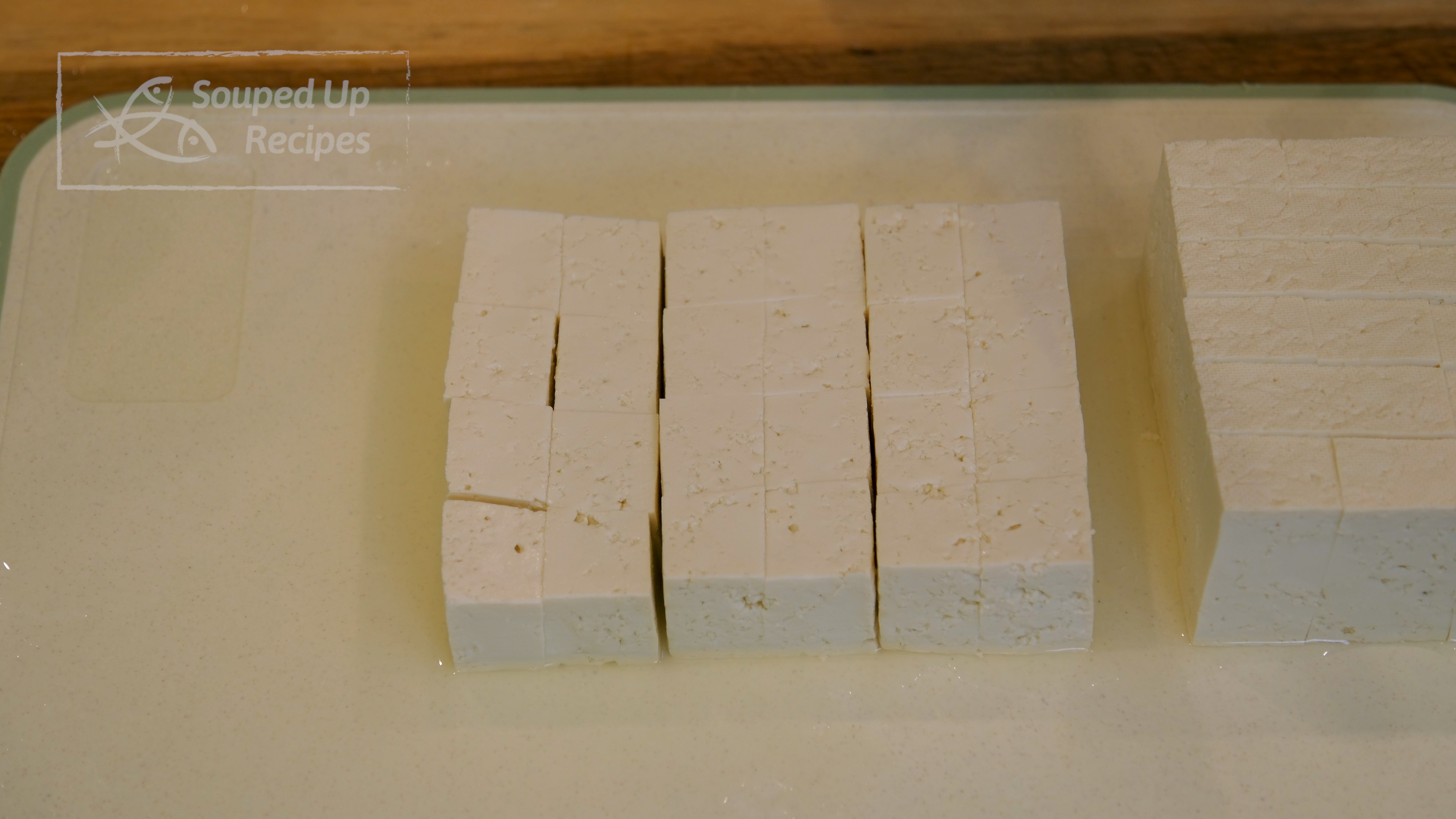 Image of Cut the firm tofu into bite-size pieces and set them...