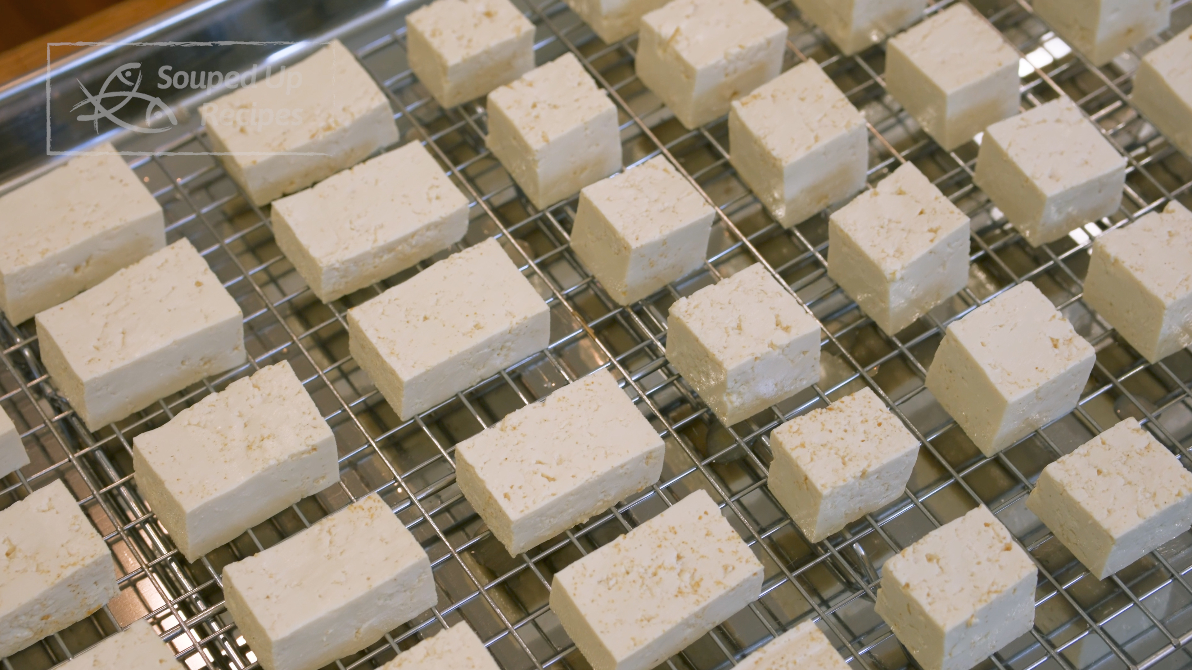 Image of Cover the tofu with the other baking tray to retain...