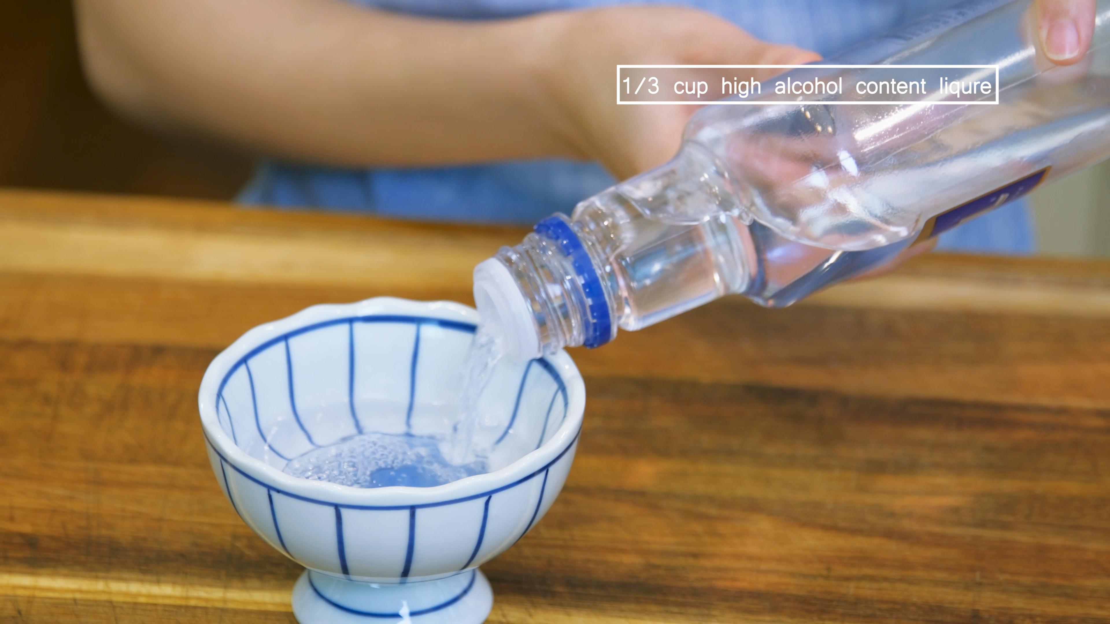 Image of Pour 1/3 cup of high-alcohol content liqueur into a bowl....