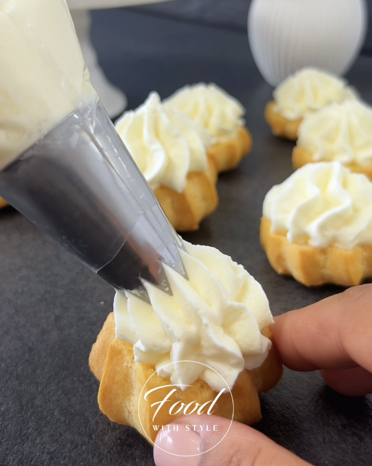 Image of Horizontally cut the cream puffs and fill them with the...