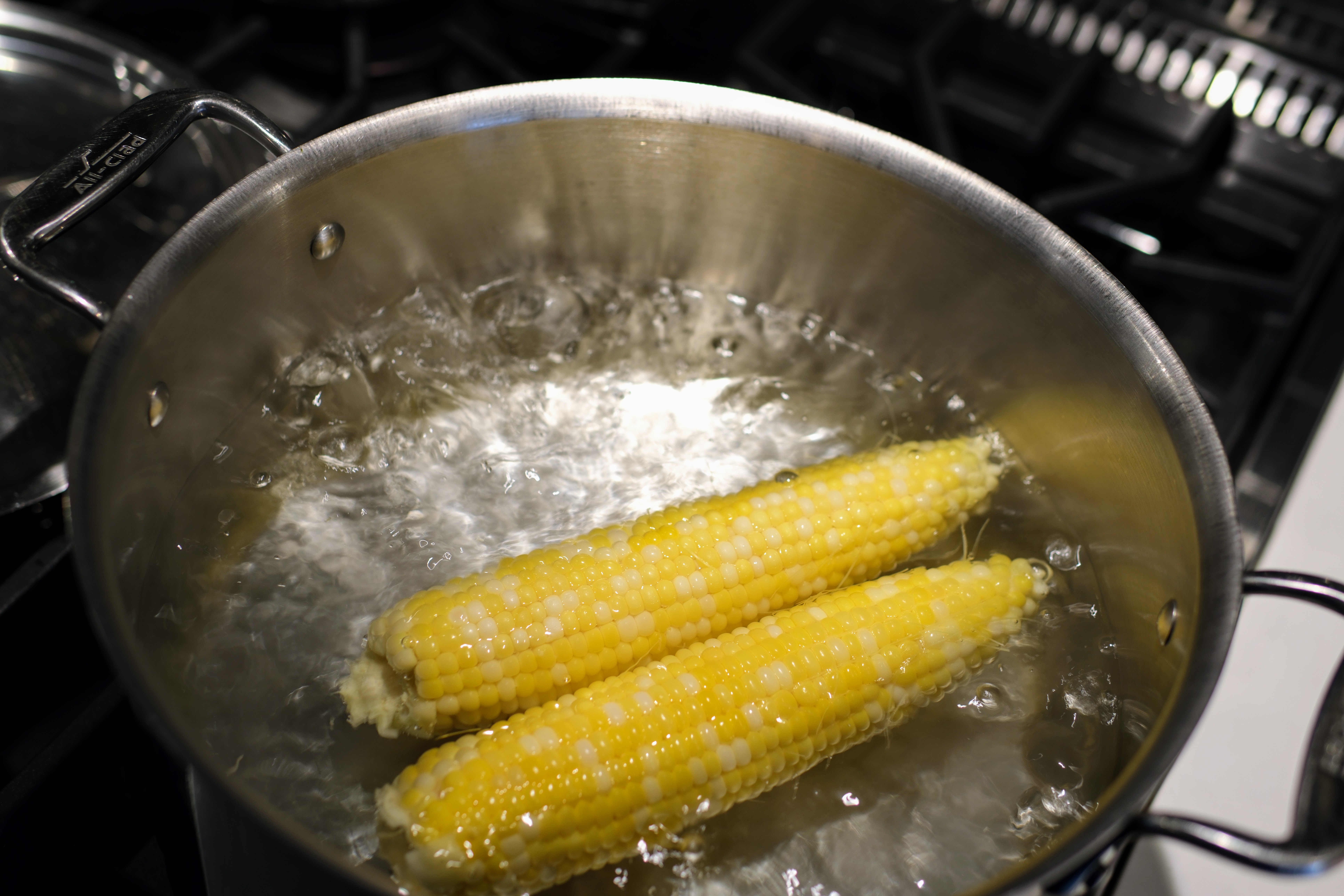 Image of Once water is boiling add corn, put the lid on...