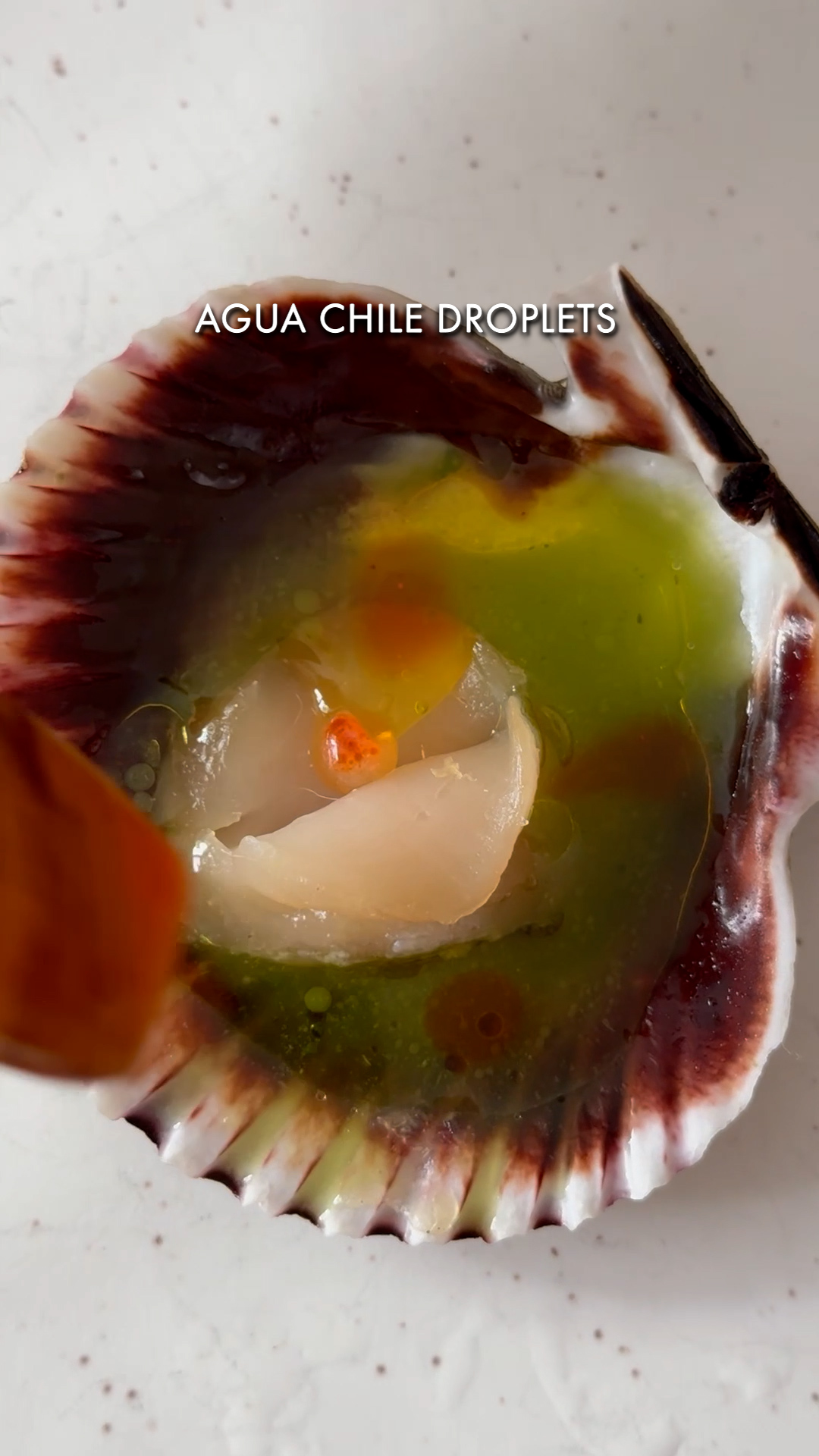 Image of Add aqua chile to the shell. Drizzle with regular olive...