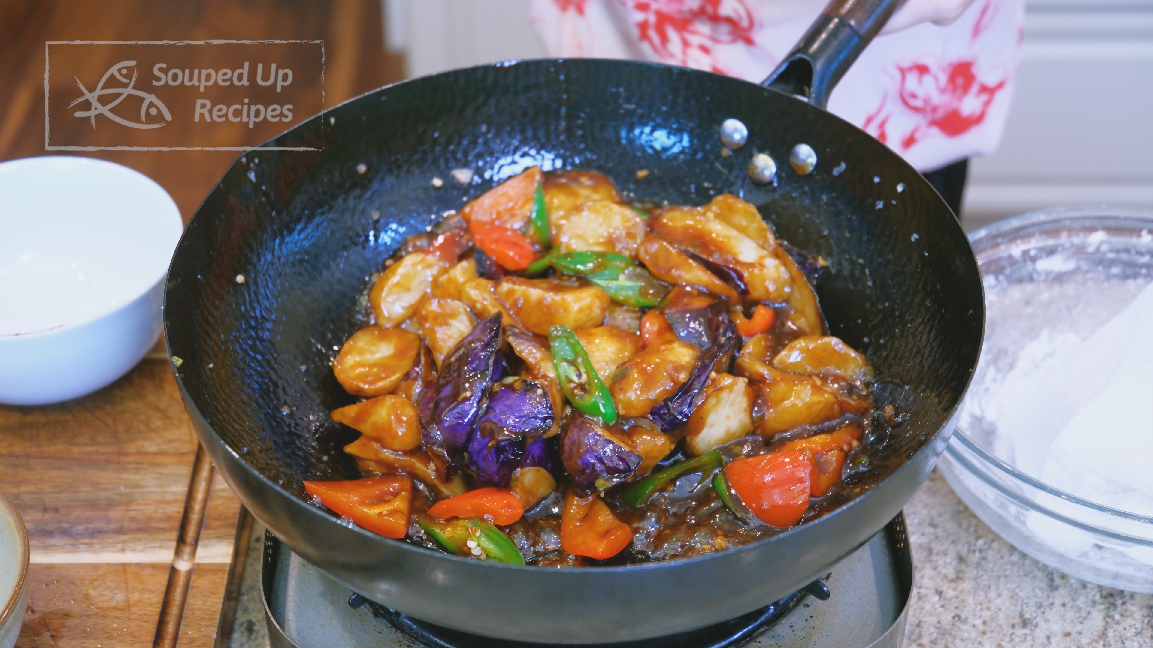 Image of Add the fried potato, eggplant, and pepper to the wok....