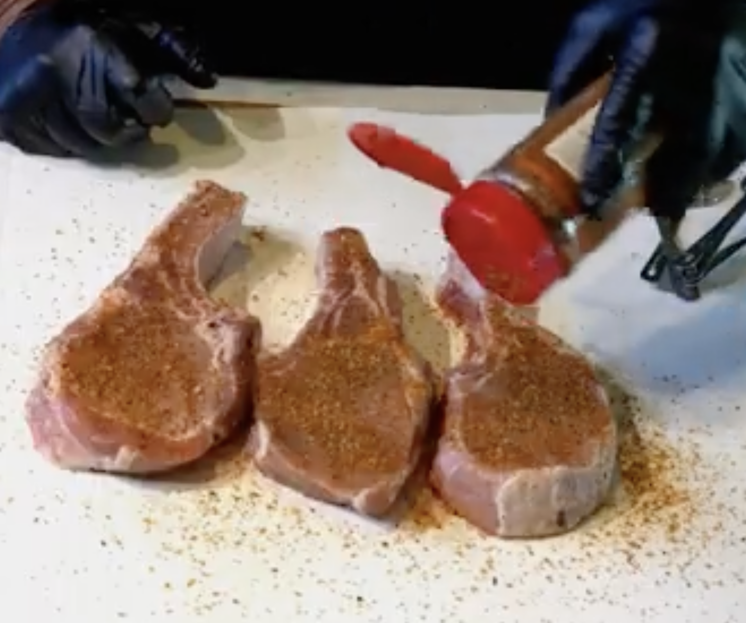 Image of Seasoning the pork chops with Sweet Money Hot. Seasoning generously...