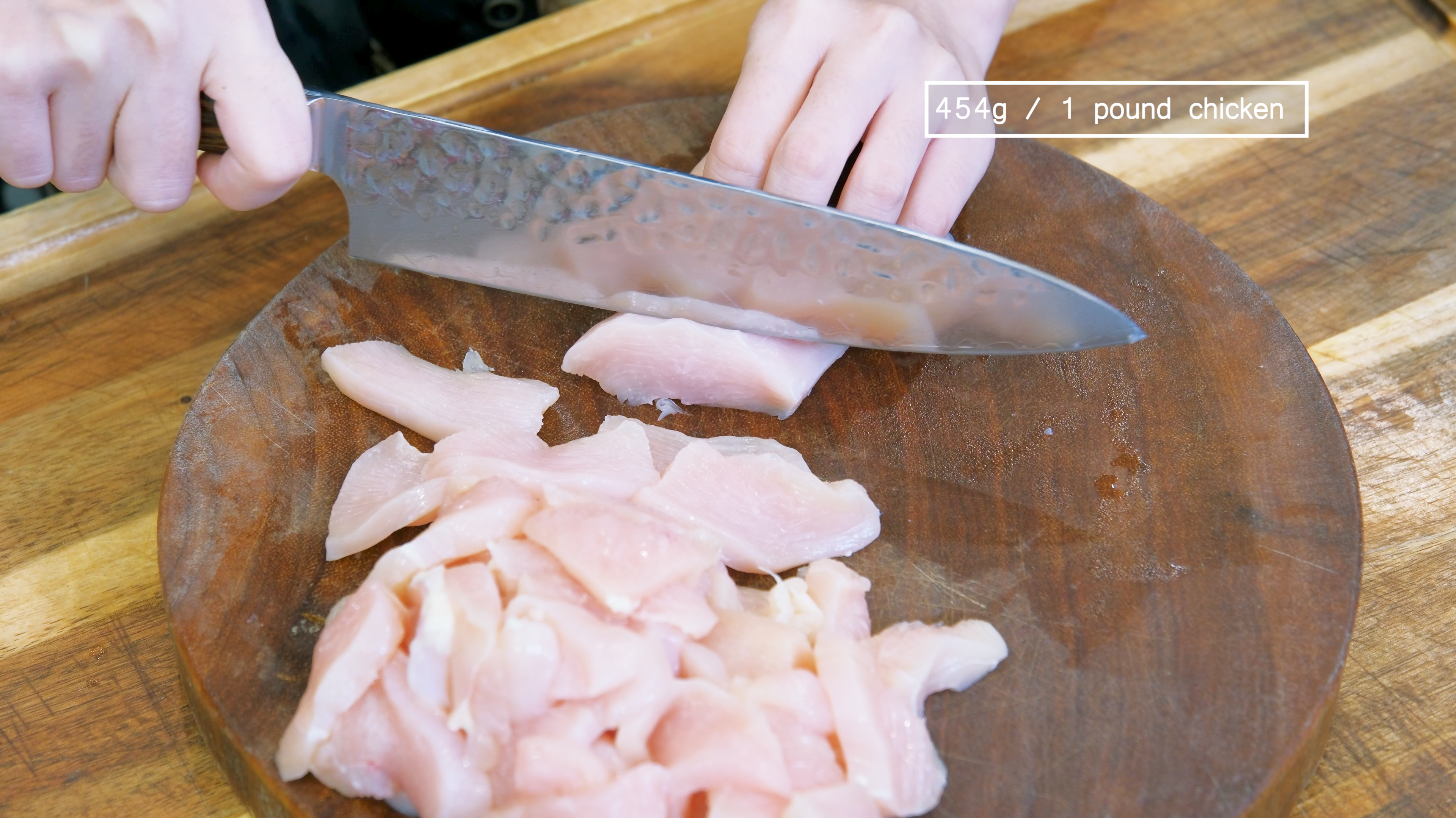 Image of Cut the chicken breast in half, then slice it into...