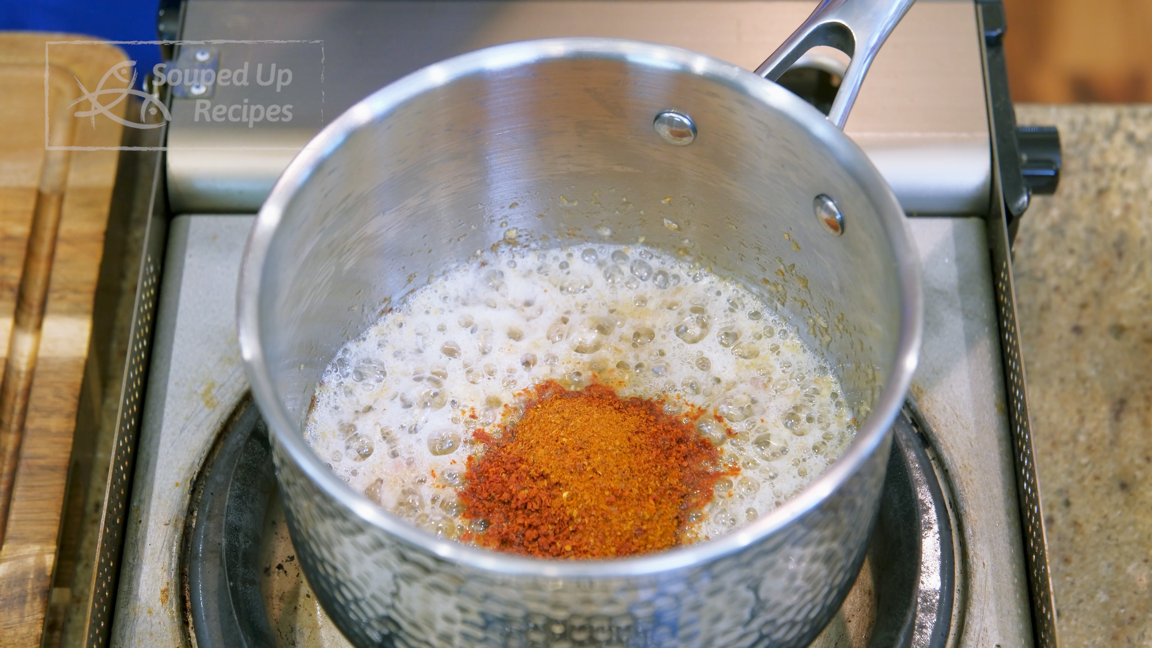 Image of Add the minced aromatics into a sauce pan along with...