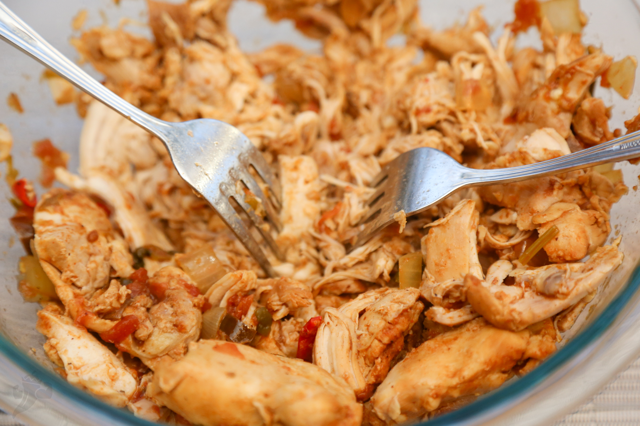 Image of remove chicken when it shreds easily, remove to another bowl...