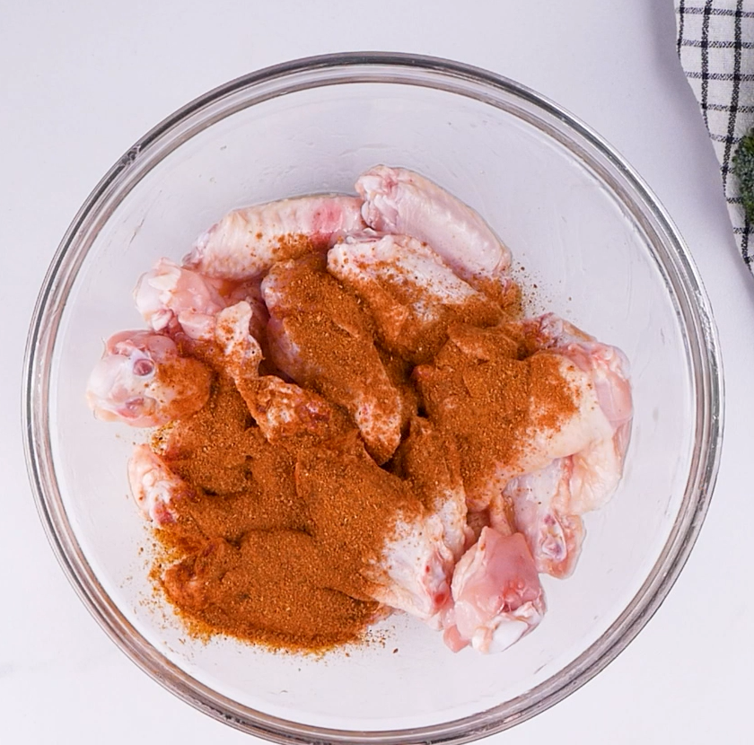 Image of Add Cajun Chicken Seasoning and mix until chicken wings are...