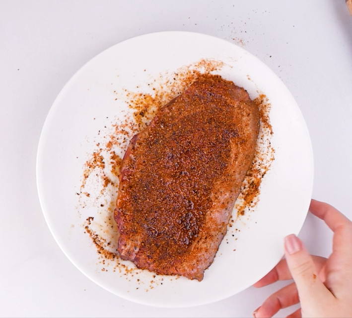 Image of Rub the steak with Ancho Steak Seasoning on both sides.