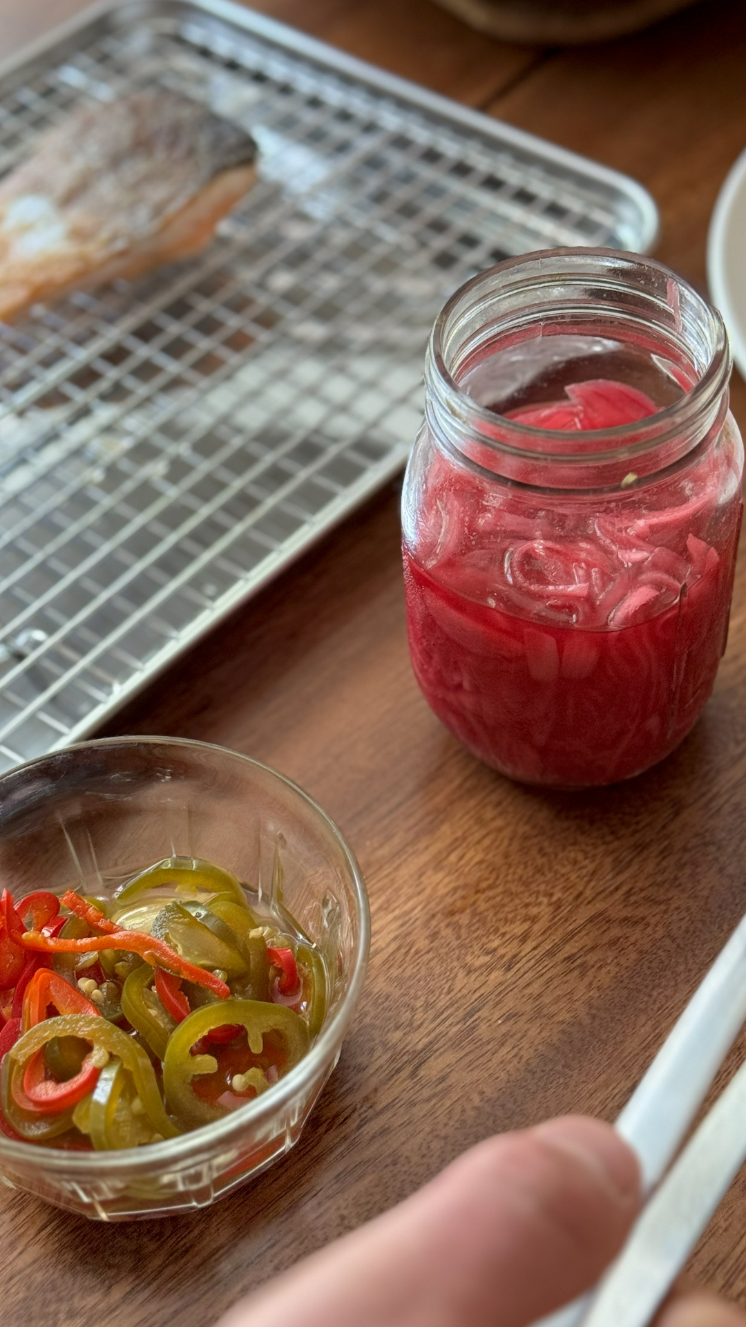 Image of Thinly slice red onions and chilies. Place them in a...