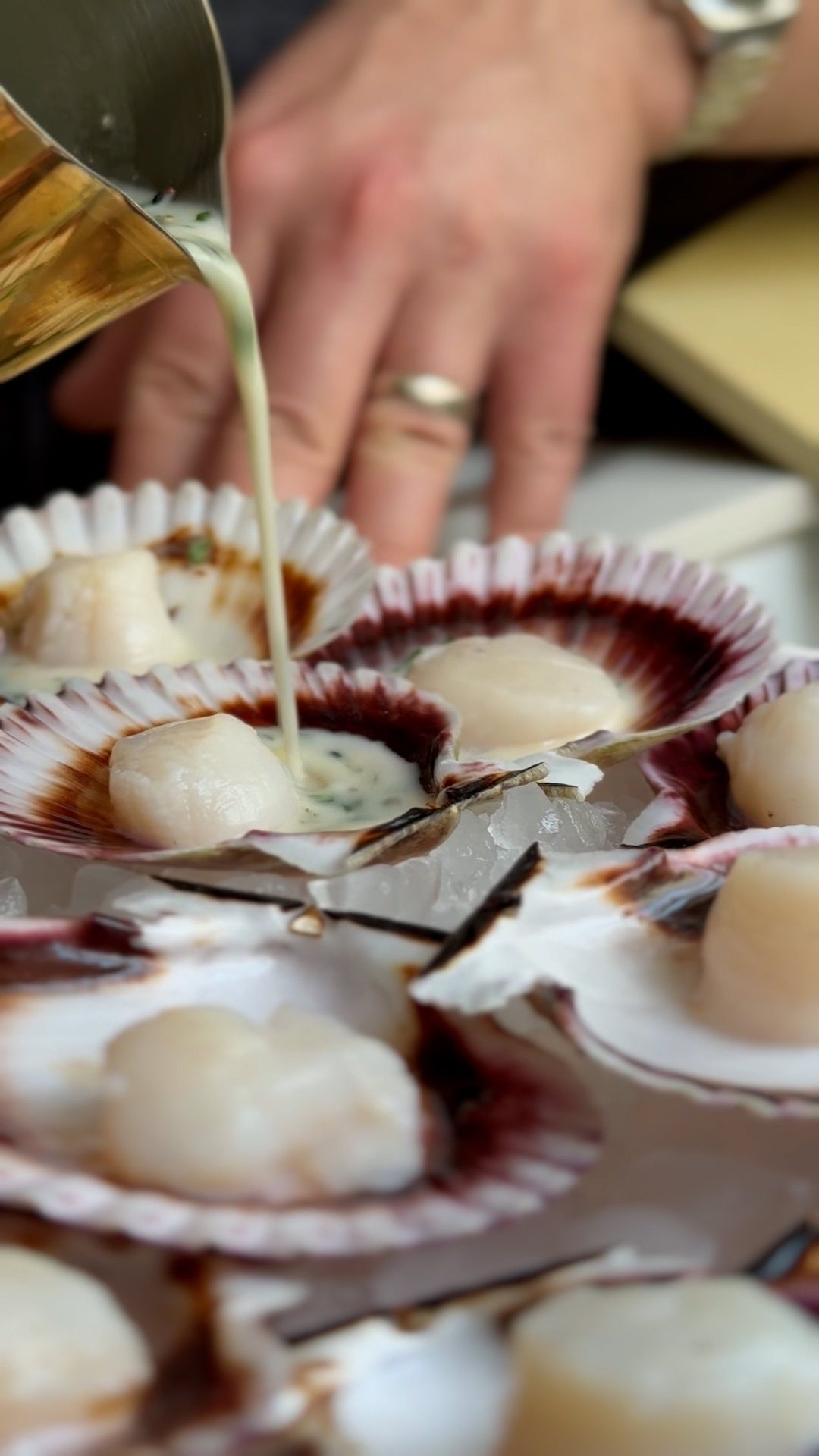 Image of Pour the sauce over the scallops: Carefully pour the prepared...