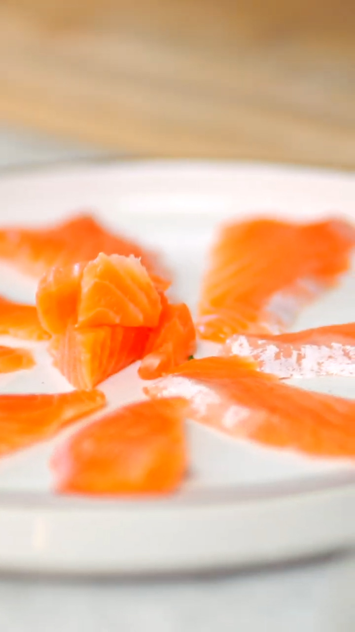 Image of Plate the steelhead: Arrange the steelhead sashimi slices on a...