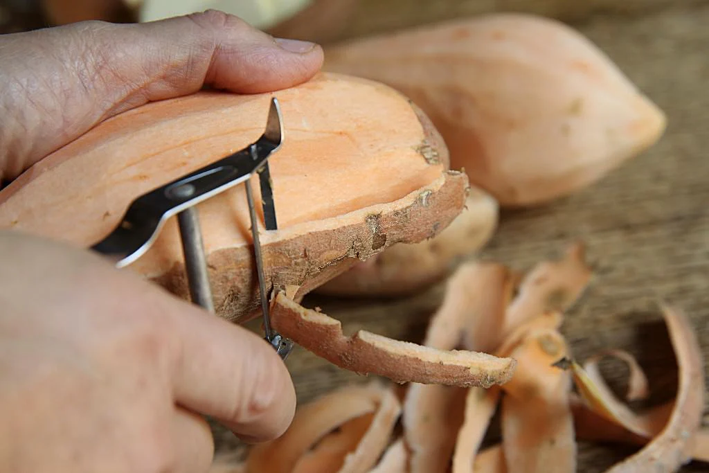 Image of Thoroughly wash and peel the sweet potatoes.