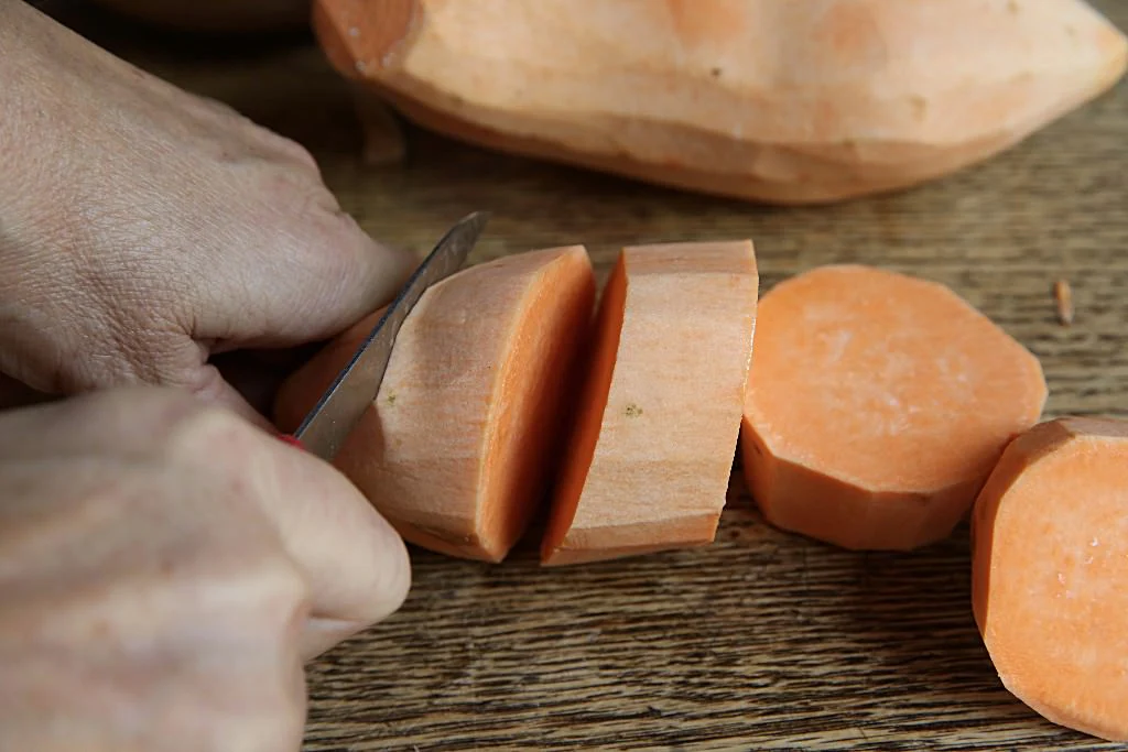 Image of Cut the sweet potatoes into even pieces.