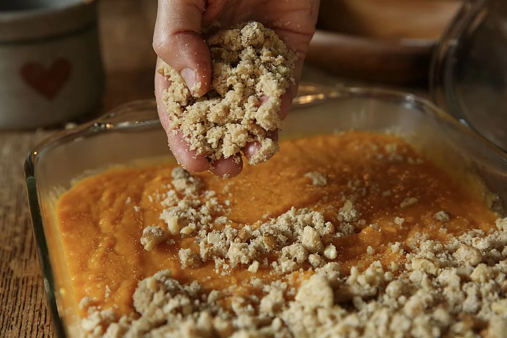 Image of Sprinkle the topping over the sweet potatoes.