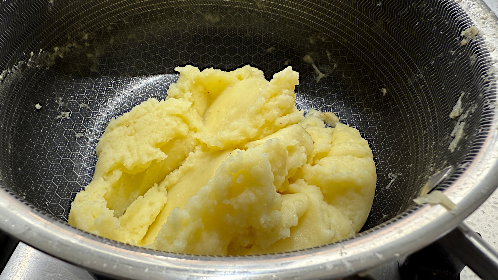 Image of pass spuds through a ricer, then mix in pepper and...