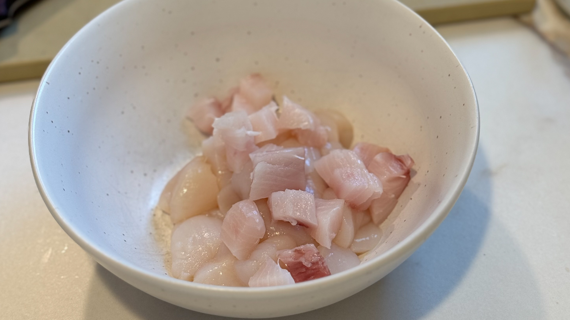 Image of Cube sushi-grade Seatopia Yellowtail and Scallops: Begin by cubing the...