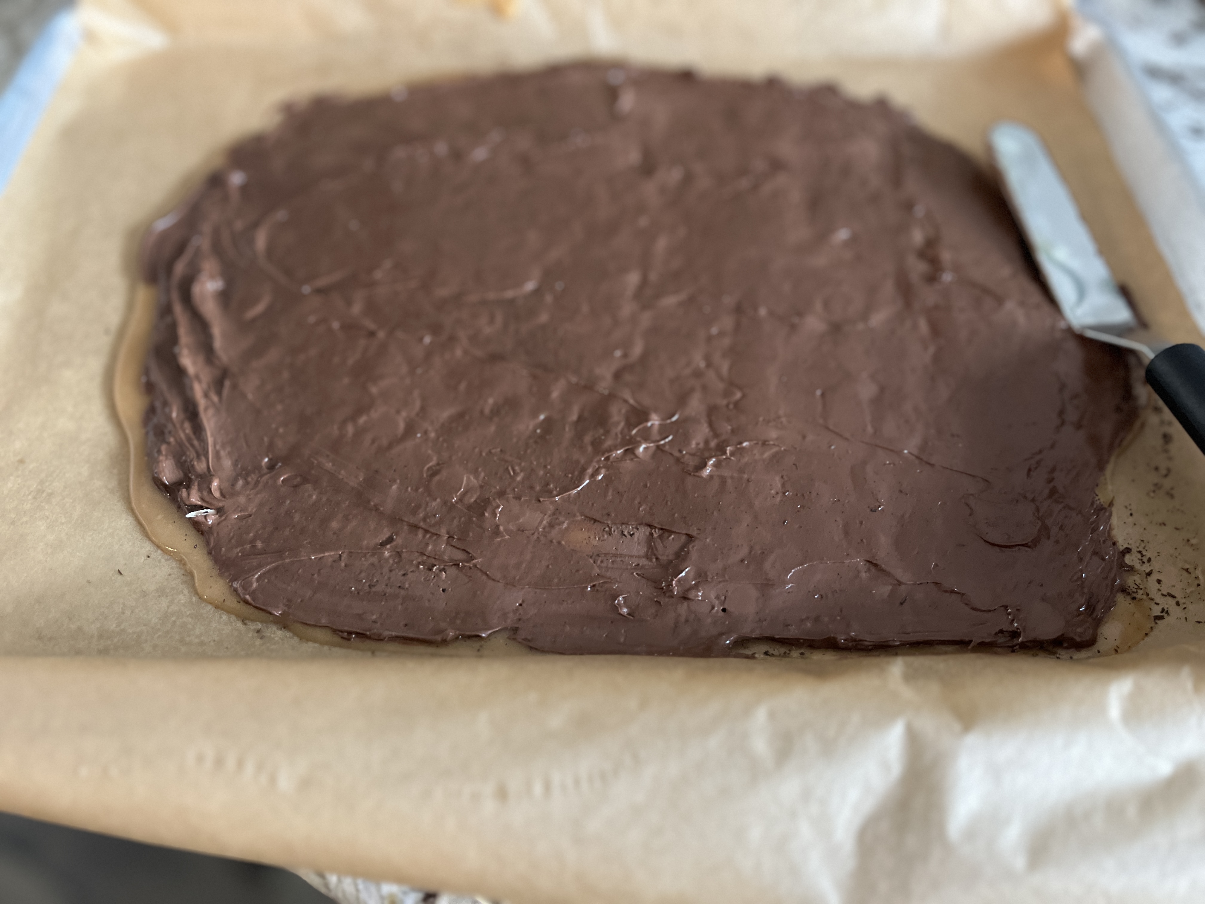 Image of With an offset spatula spread the chocolate to coat the...